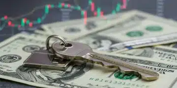 House key on dollar bills with rising financial chart, symbolizing mortgage refinancing outlook.